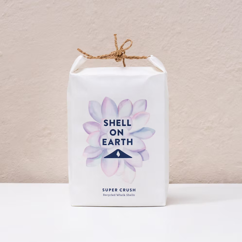 White packaging with floral design and 'Shell on Earth' text on a beige background