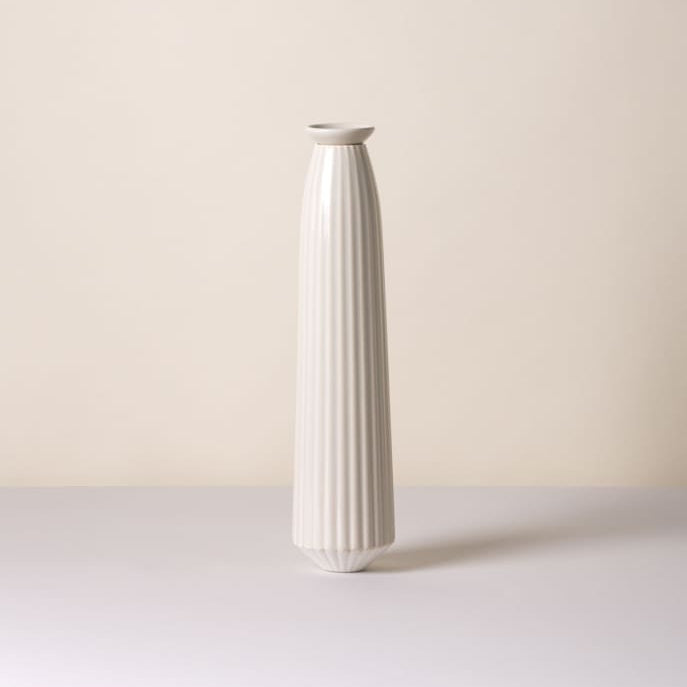 A tall, slender ceramic Bergs Potter Cove watering spike with vertical fluted ridges, standing on a light surface against a warm off-white background.