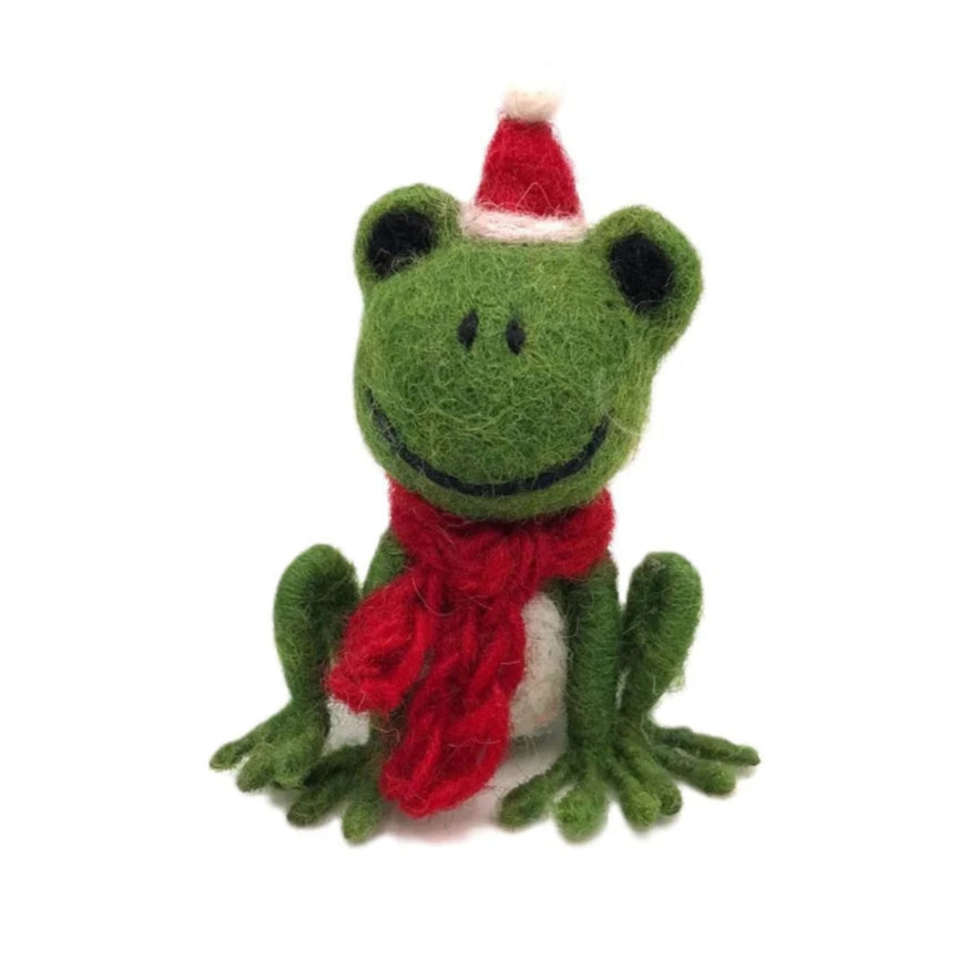 Felted frog toy with a red scarf and Santa hat on a white background