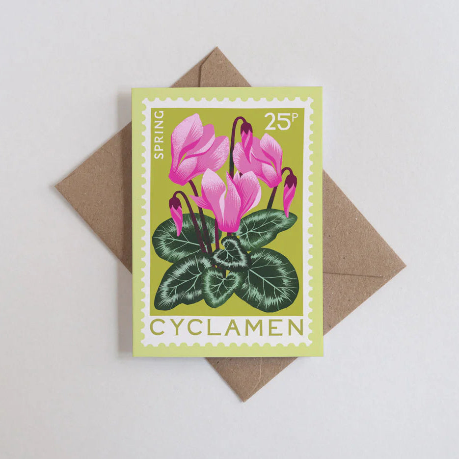 Card with cyclamen illustration and brown envelope on light gray background