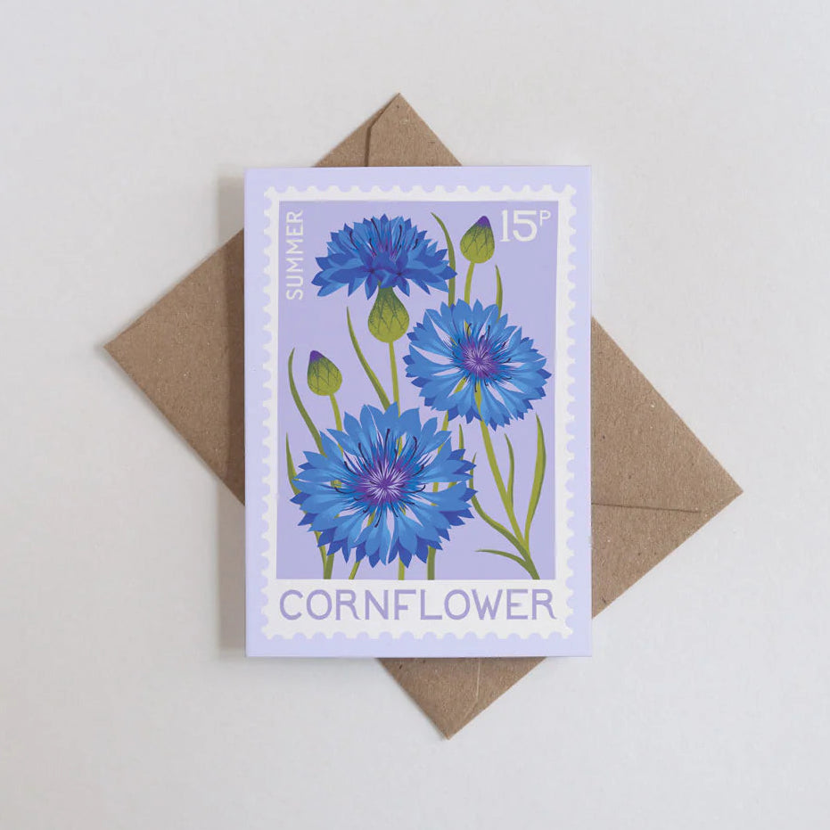 Card with cornflower design and brown envelope on light gray background