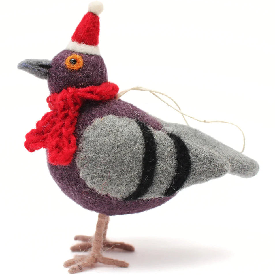 Decorative pigeon ornament with a red scarf and Santa hat on a white background