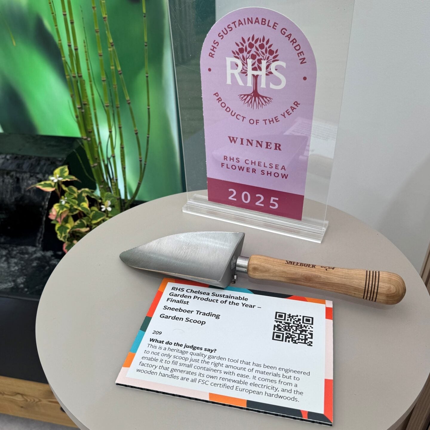 Sneeboer Compost Scoop wins the RHS Product of the Year award. Displayed here on a table with the award at the Royal Horticultural Society's Chelsea Garden Show in 2025.