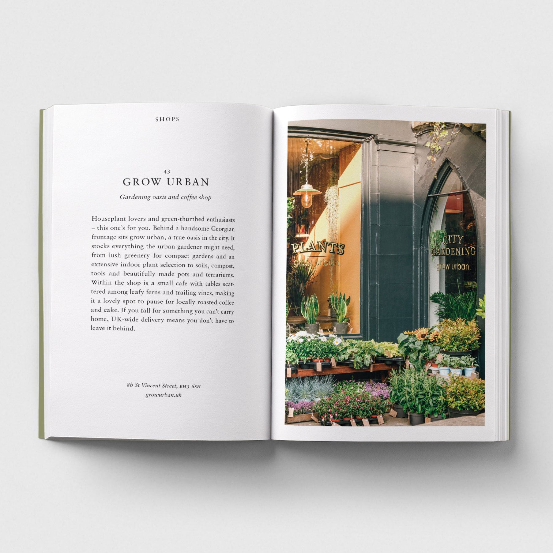 An open book laid flat on a light grey background, showing a printed interior page with text on the left and a colour photograph of the grow urban. Edinburgh storefront with plants on the right.