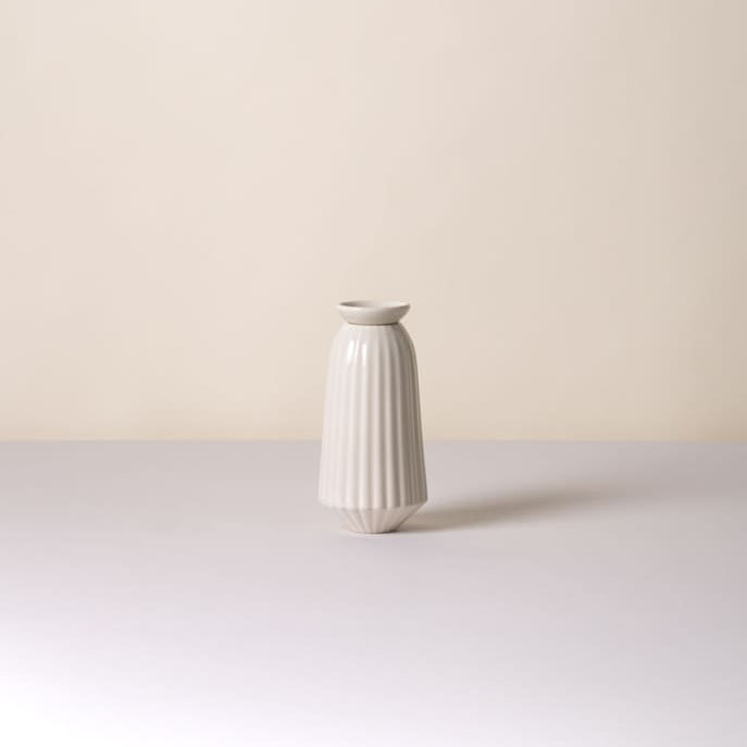 White ceramic Bergs Potter Cove watering spike on a light gray surface with a beige background