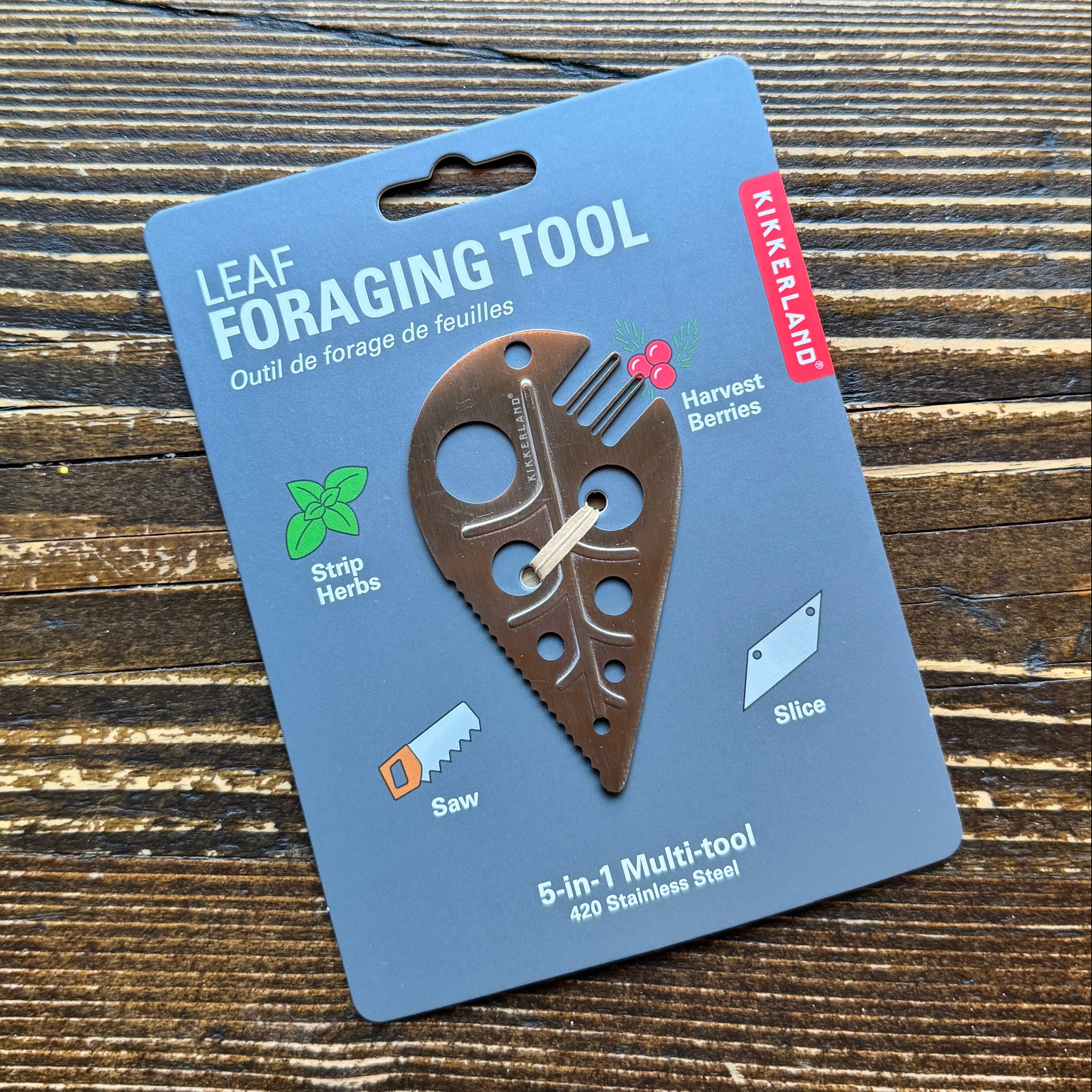 Leaf foraging tool on a blue Katterland branded card against a wooden background