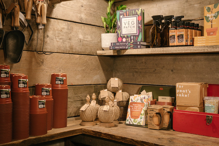 A potting shed with plant care products within the interior of an Edinburgh plant shop.